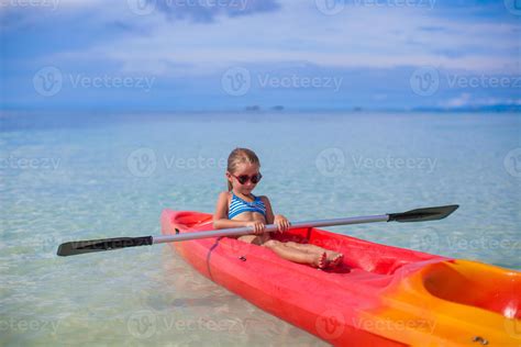 Little cute girl kayaking in the clear blue sea 18038846 Stock Photo at Vecteezy