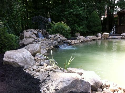 A Pond With Rocks And Water Running Through It