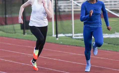 Two high school girls sprinters racing in the cold - The Sentinel