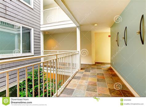 Modern Apartment Building Hallway And Door Near Railing Stock Photo