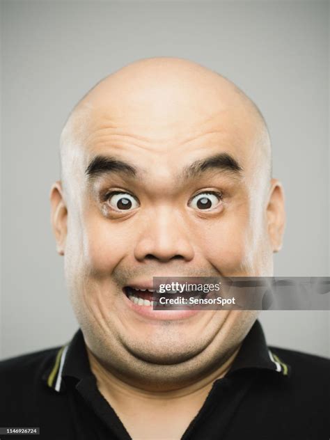 Portrait Of Real Chinese Adult Man With Surprised Expression Looking At