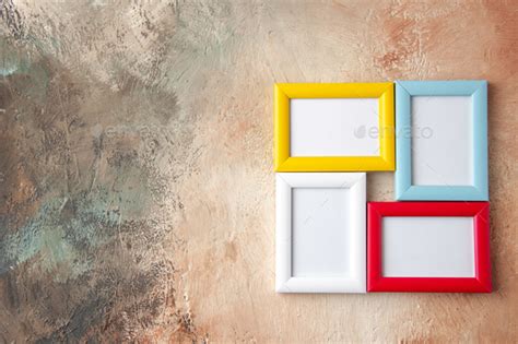 Close Up View Of Colorful Picture Frames Hanging On Nude Color Wall