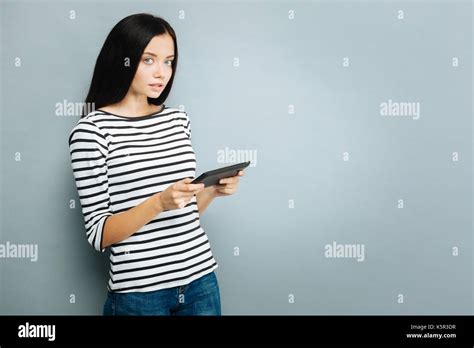 Serious Brunette Holding Her Tablet Stock Photo Alamy