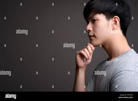 Profile View Of Young Handsome Asian Man Thinking Stock Photo Alamy