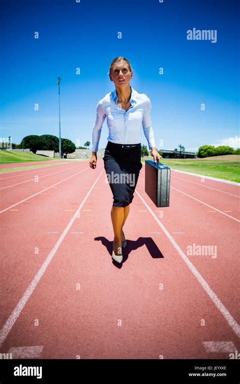 Businesswoman Running On A Running Track Stock Photo Alamy