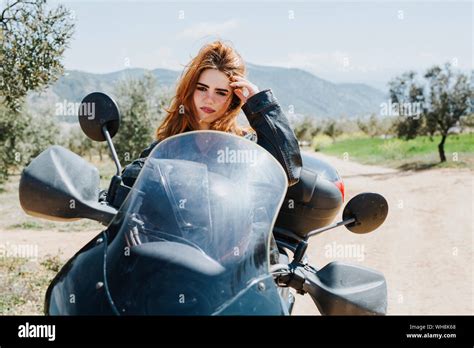 Portrait Of Redheaded Woman On Motorbike Hi Res Stock Photography And