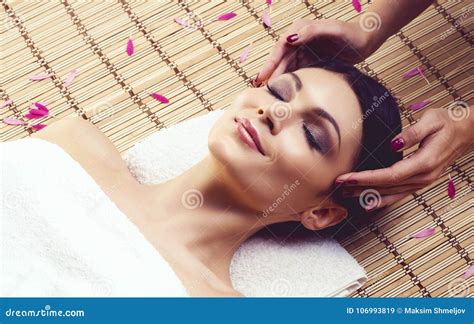 Healthy And Beautiful Woman Getting Massage Treatment In Spa Salon