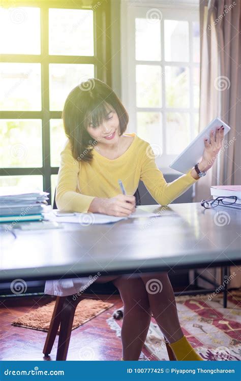 Young Asian Woman Students Using Tablets And Writing Note In College