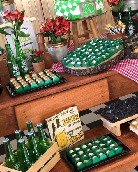 A Table Filled With Lots Of Green And Red Food On Top Of Wooden Trays