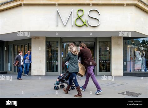 High Street Shoppers Are Pictured Walking Past A Marks And Spencer