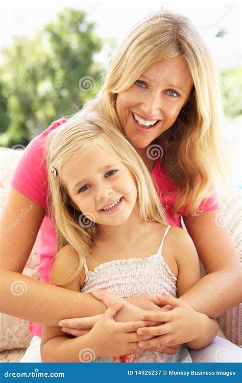 Portrait Of Mother And Daughter Relaxing On Sofa Stock Image Image Of