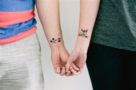 Minnie Mouse And Mickey Mouse Kissing Tattoo