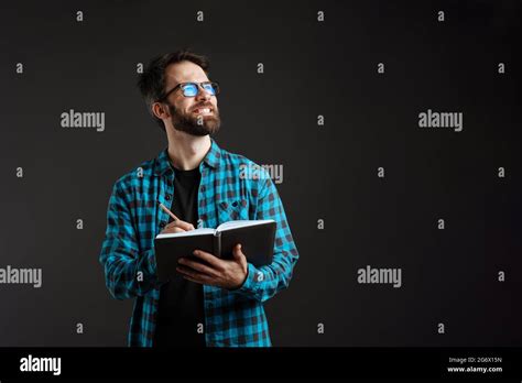Bearded Brunette Man In Shirt Smiling While Writing Down Notes Isolated