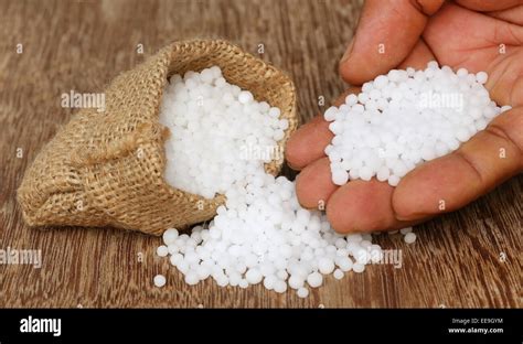 Close Up Of Some Urea Fertilizer In Sack With Human Hand Stock Photo