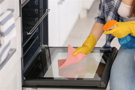 Woman Cleaning Oven In Kitchen Closeup Stock Image Everypixel