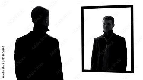 Man Looking In Mirror