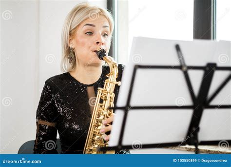 Saxophonist Woman With Her Musical Instrument At The Window Stock Image