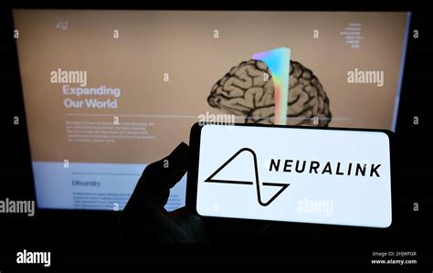 Person Holding Smartphone With Logo Of Us Neurotechnology Company