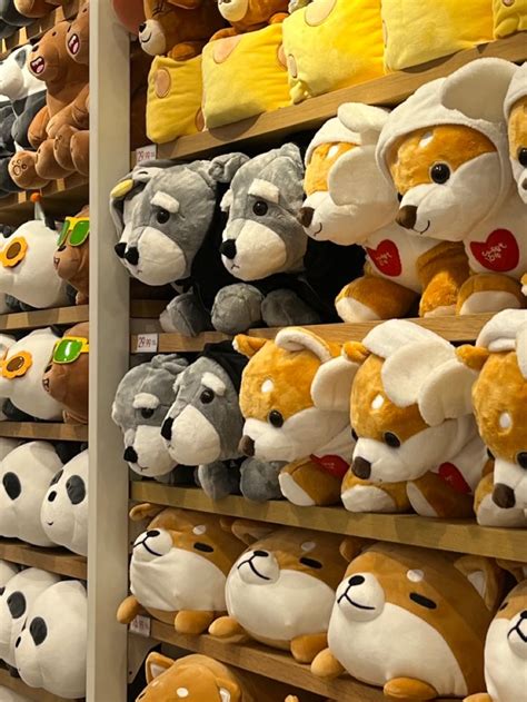 many stuffed animals are on display in a store