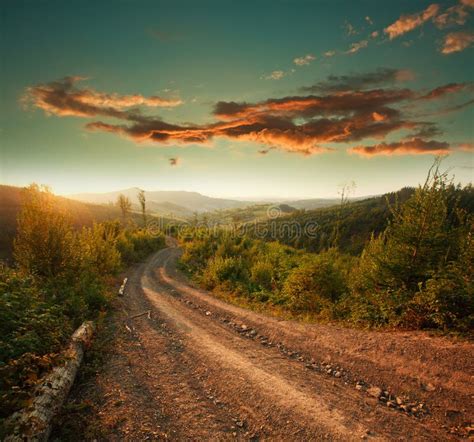 Mountain Road At Sunset With Dramatic Cloudy Sky Stock Image - Image of ...