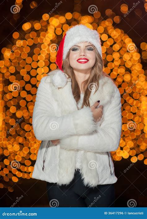 Fashionable Lady Wearing Xmas Hat And White Fur Coat Outdoor Portrait