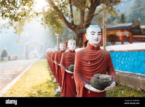 Row Of Buddhist Monk Statues Holding Ban Bats Kaw Ka Thawng Cave Hpa