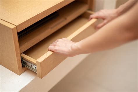 Premium Photo Woman Hand Pull Open Drawer Wooden Cabinet