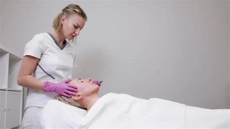 Professional Beautician Doctor In Pink Medical Gloves Making