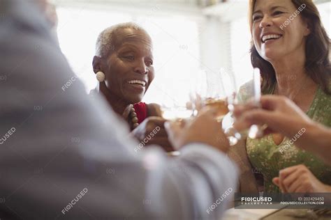 Smiling Mature Women Drinking Wine Dining At Restaurant People