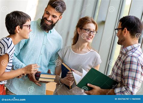 Happy Group Of Students Studying And Working Together In A College