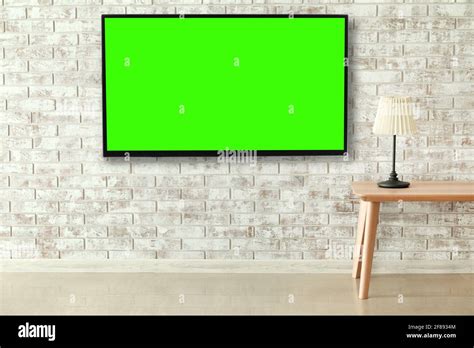 Modern Tv Set Hanging On Brick Wall In Living Room Stock Photo Alamy