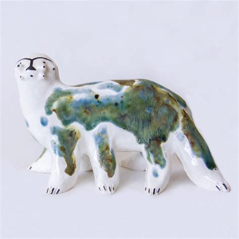 A Ceramic Polar Bear Figurine On A White Background