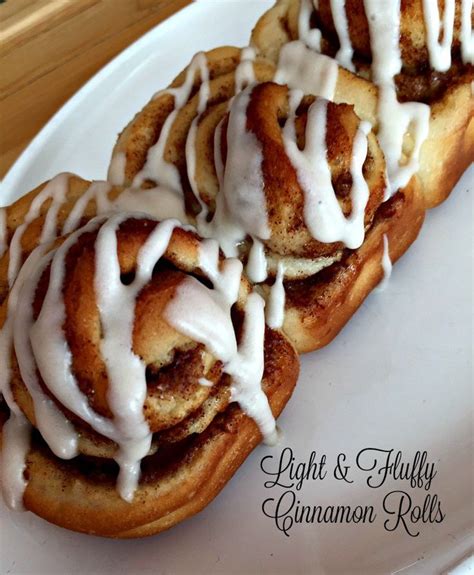 Cinnamon Rolls With Icing On A White Plate