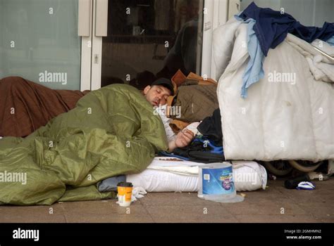 Homeless Man Sleeping Rough In A Sleeping Bag Commercial Road Shopping