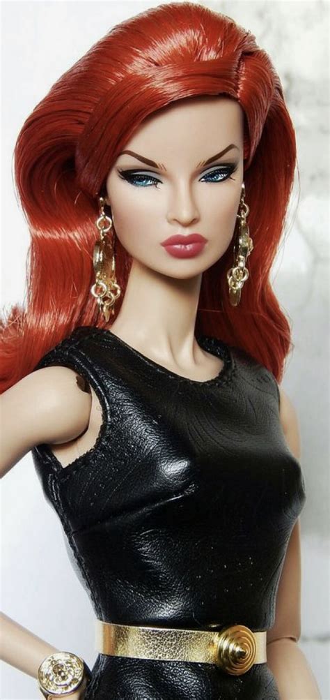 A Barbie Doll With Red Hair Wearing A Black Leather Dress And Gold