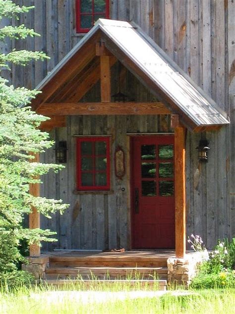 A Small Wooden Cabin With Red Doors And Steps Leading To The Front Door