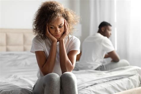 Premium Photo Unhappy Black Couple Sitting On Different Sides Of Bed