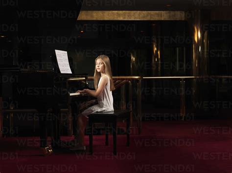 Portrait Of Girl Playing Piano On Stage Stock Photo