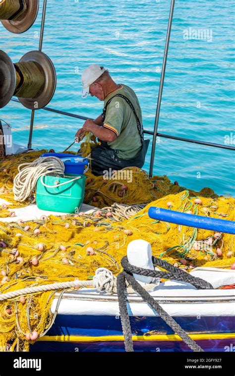 Greek Fisherman Mending Nets On Zante Fisherman In Greece On Boat