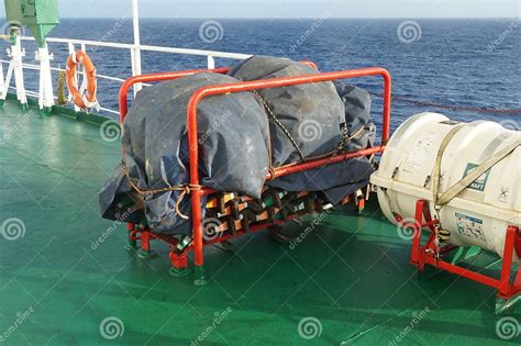 White Life Raft And Embarkation Ladder On Deck Of Container Ship Ready