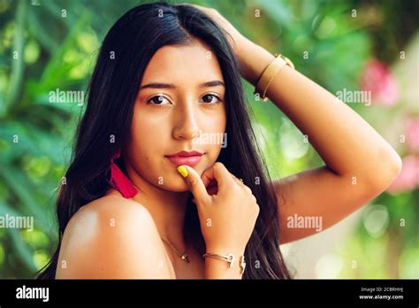 Closeup Of Young Latin Girl With Long Black Hair And Black Eyes Looking At The Camera With One