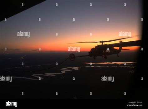 A Uh 60 Black Hawk Connects With The Fuel Hose Of A Kc 130j Super