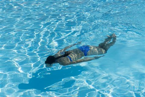 Woman With Swimsuit Swimming On A Blue Water Pool Underwater Woman Portrait With Blue Bikini In
