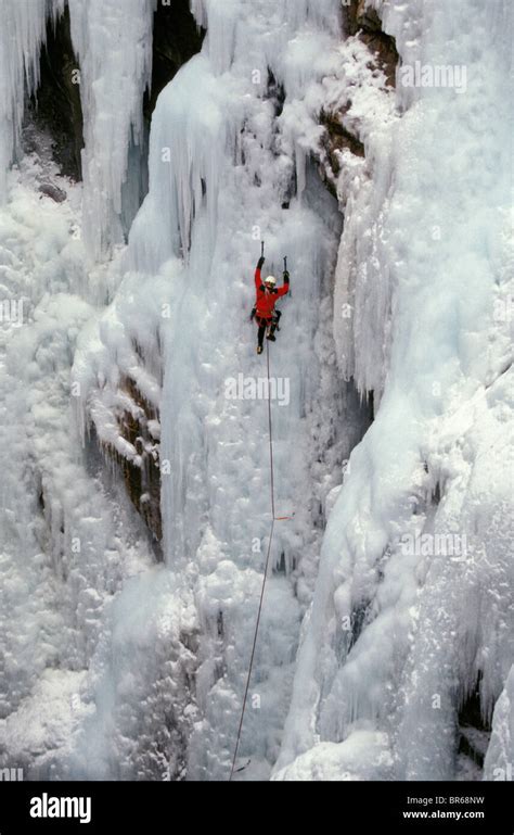 A Man Ice Climbing On A Frozen Waterfall Stock Photo Alamy