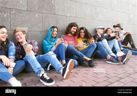 Young Multiracial Group Of Friends Using Mobile Smartphone Outdoor