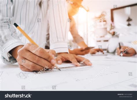 Engineers Pointing Building On Blueprint Drawing Stock Photo 1415122967