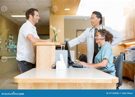 Patient With Doctor And Nurse At Reception Desk Stock Photo Image Of