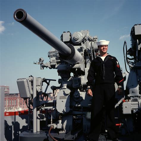 A Crewman Poses Beside The Mark 33 3 Inch 50 Caliber Gunmount Aboard The Dock Landing Ship Uss