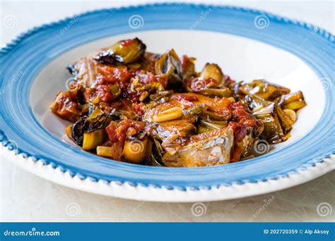 Bonito Fish Pieces With Tomato Sauce And Leek In Plate Baked In Oven