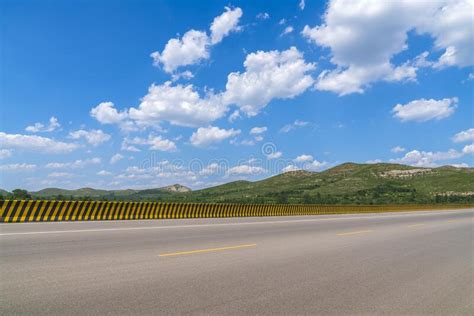 Asphalt Highway Landscape Under Blue Sky And White Clouds Stock Photo